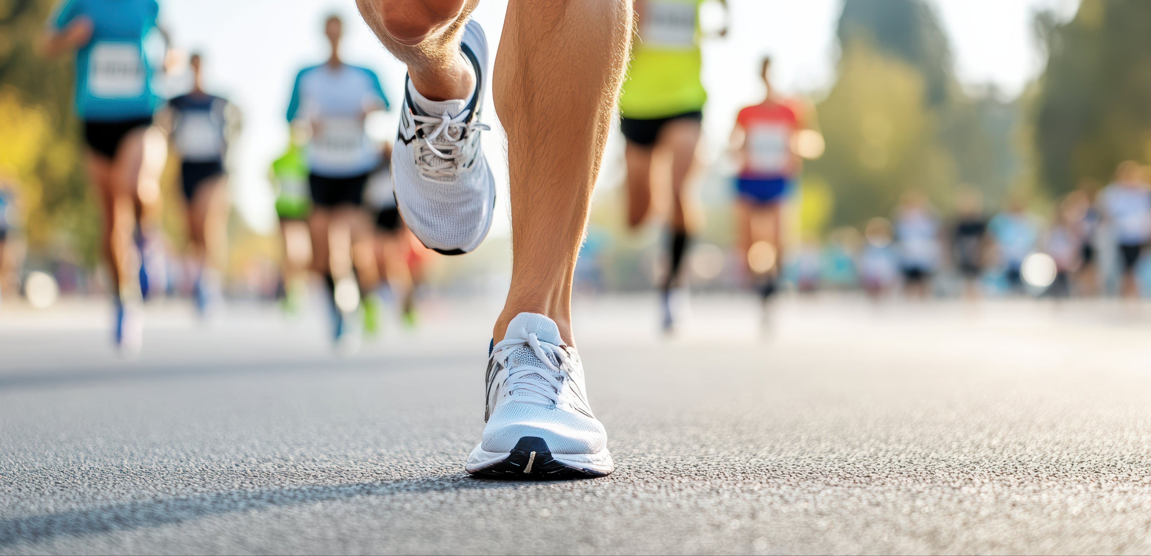 Close-up of running shoes with a blurred background of a marathon.